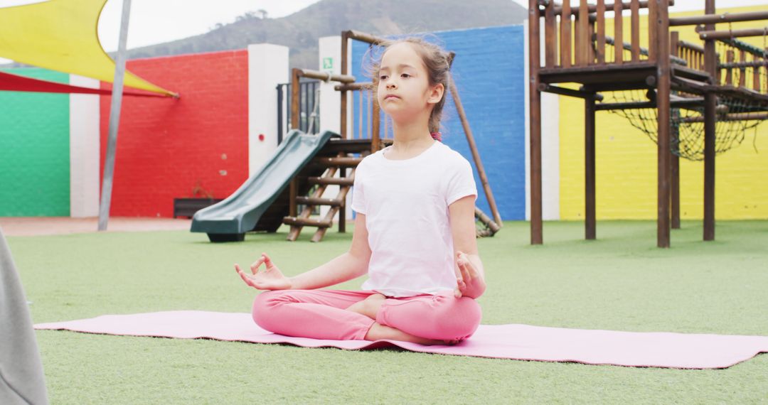 Young Girl Practicing Yoga Outdoors at Colorful Playground - Free Images, Stock Photos and Pictures on Pikwizard.com