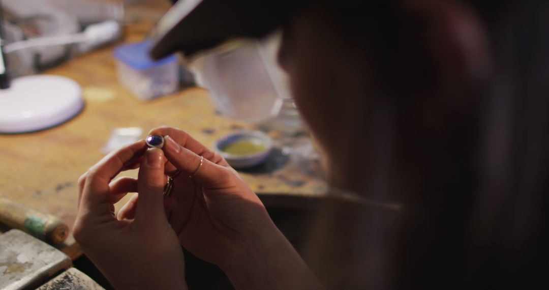 Focused Jeweler Inspecting Precision in Handmade Jewelry Craft