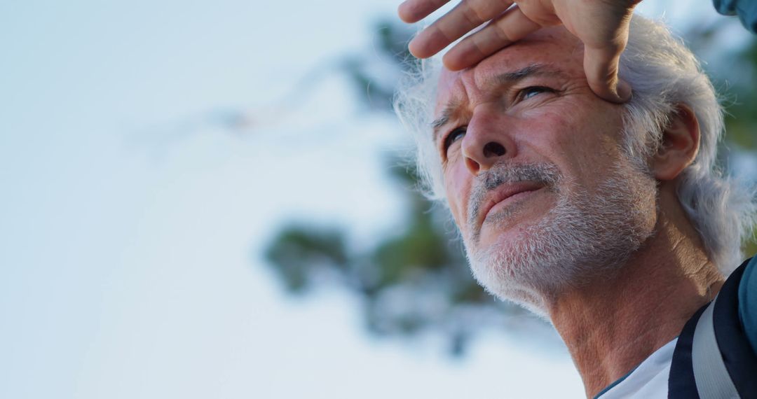 Elderly Man Gazing Thoughtfully Into Distance Outdoors - Free Images, Stock Photos and Pictures on Pikwizard.com