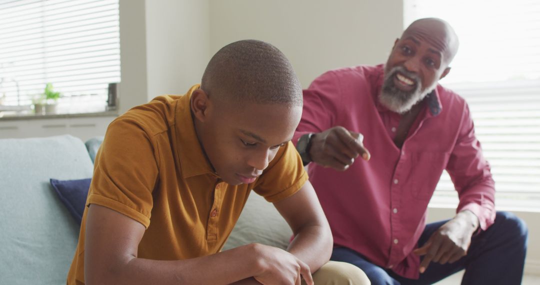 Image of nervous african american father yelling on son at home - Free Images, Stock Photos and Pictures on Pikwizard.com