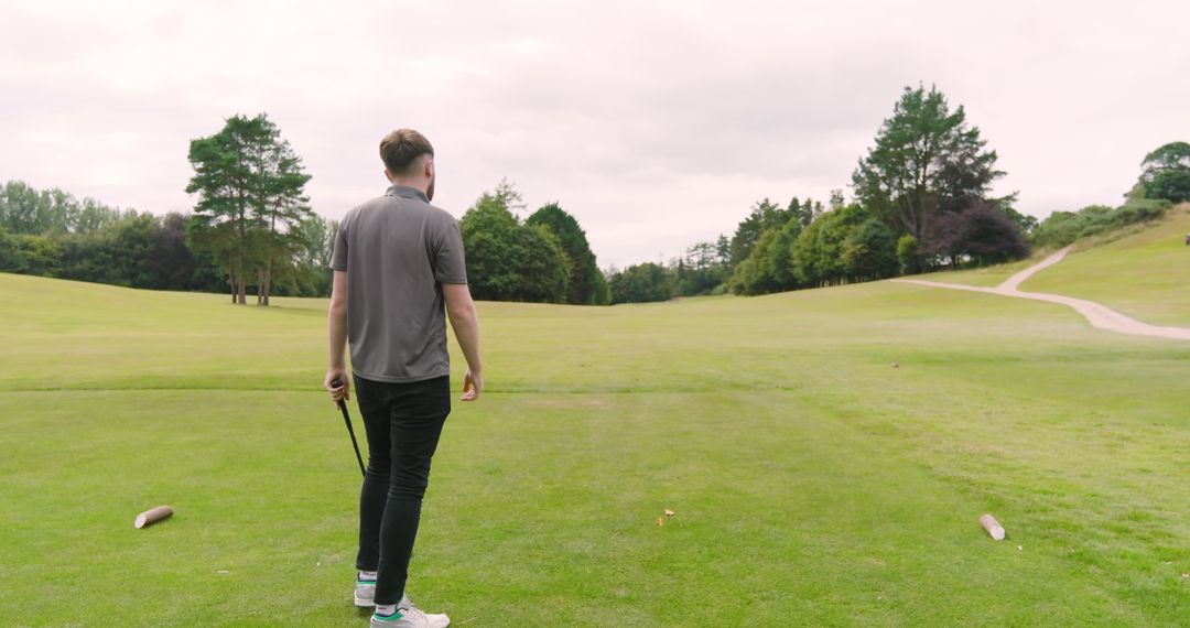 Golfer Standing on Serene Course Near Teeing Ground