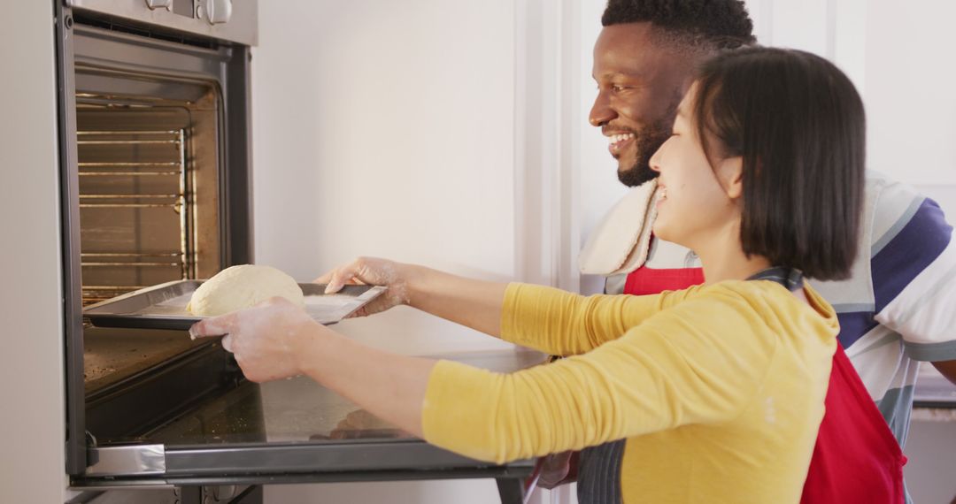 Multiracial couple baking bread together in kitchen - Free Images, Stock Photos and Pictures on Pikwizard.com