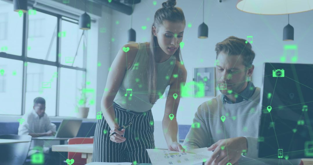 Colleagues Collaborating on Digital Technology Project in Modern Office