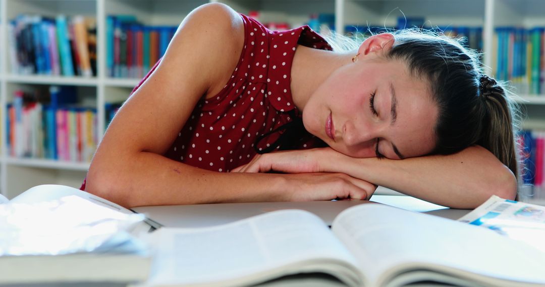 Exhausted Student Sleeping at Study Table with Open Books