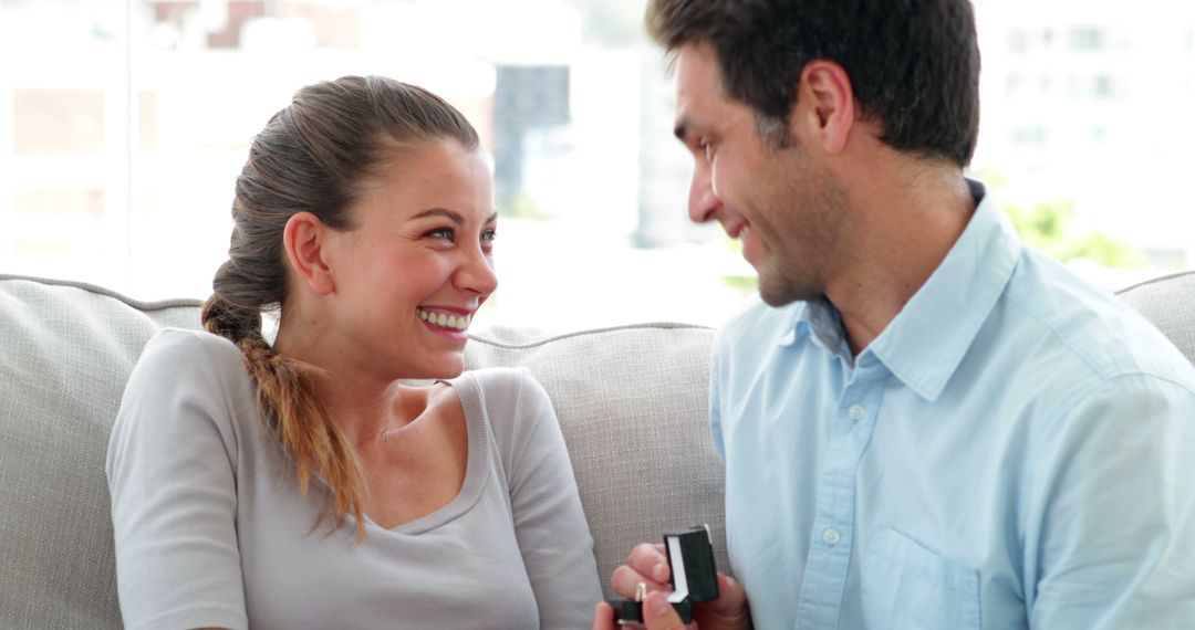 Man Proposing to Girlfriend with Engagement Ring at Home