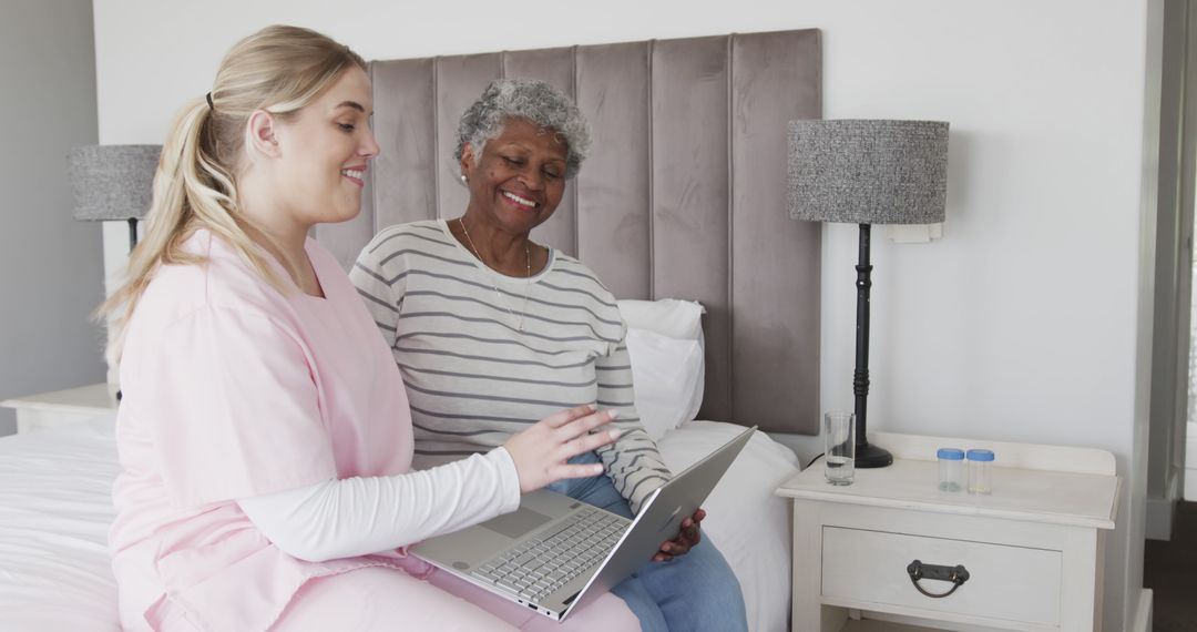 Nurse Assisting Elderly Woman with Laptop in Senior Care Home - Free Images, Stock Photos and Pictures on Pikwizard.com