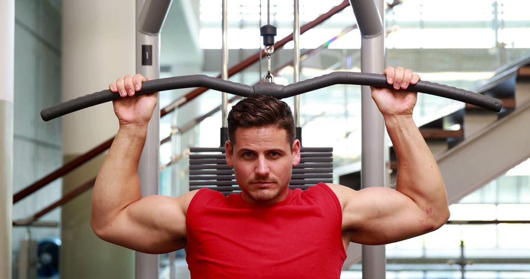 Muscular Man Exercising on Lat Pulldown Machine at Gym - Free Images, Stock Photos and Pictures on Pikwizard.com