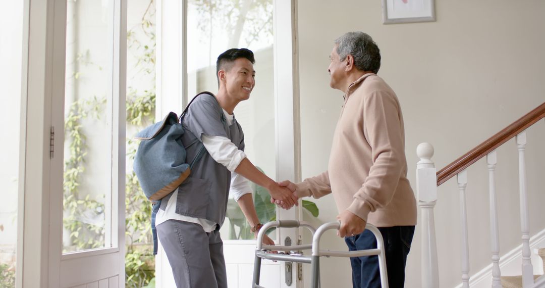 Senior Man Greeting Caregiver with Handshake at Home Entrance - Free Images, Stock Photos and Pictures on Pikwizard.com