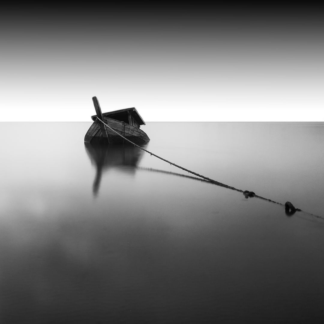Solitary Boat Anchored on Calm Misty Lake at Dawn - Free Images, Stock Photos and Pictures on Pikwizard.com