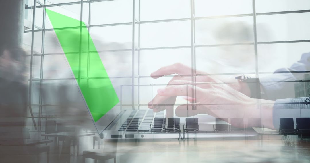 Hands Typing on Laptop with Green Screen in Bustling Office