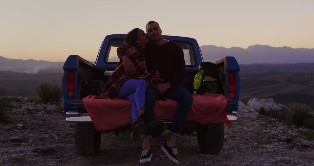 Couple Sitting in Truck Bed Enjoying Sunset in Countryside - Free Images, Stock Photos and Pictures on Pikwizard.com