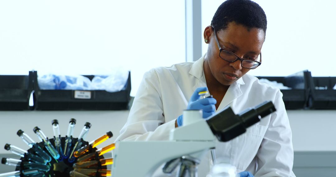 Female Scientist Conducting Laboratory Experiments with Microscope
