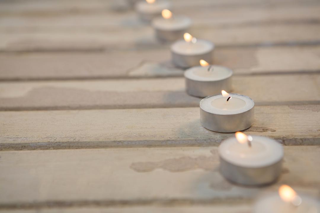 Candles burning on wooden plank - Free Images, Stock Photos and Pictures on Pikwizard.com