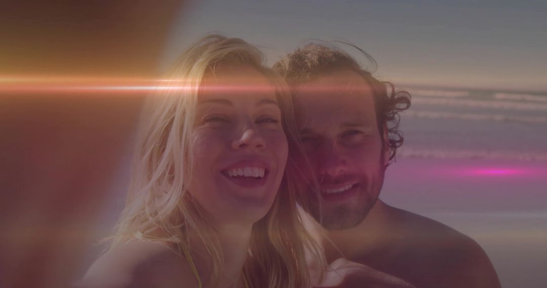 Smiling Couple Taking Selfie at Beach with Lens Flare
