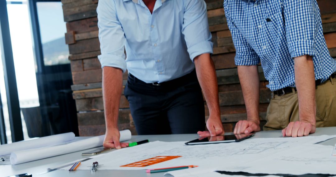 Engineers Reviewing Blueprints in Modern Office - Free Images, Stock Photos and Pictures on Pikwizard.com