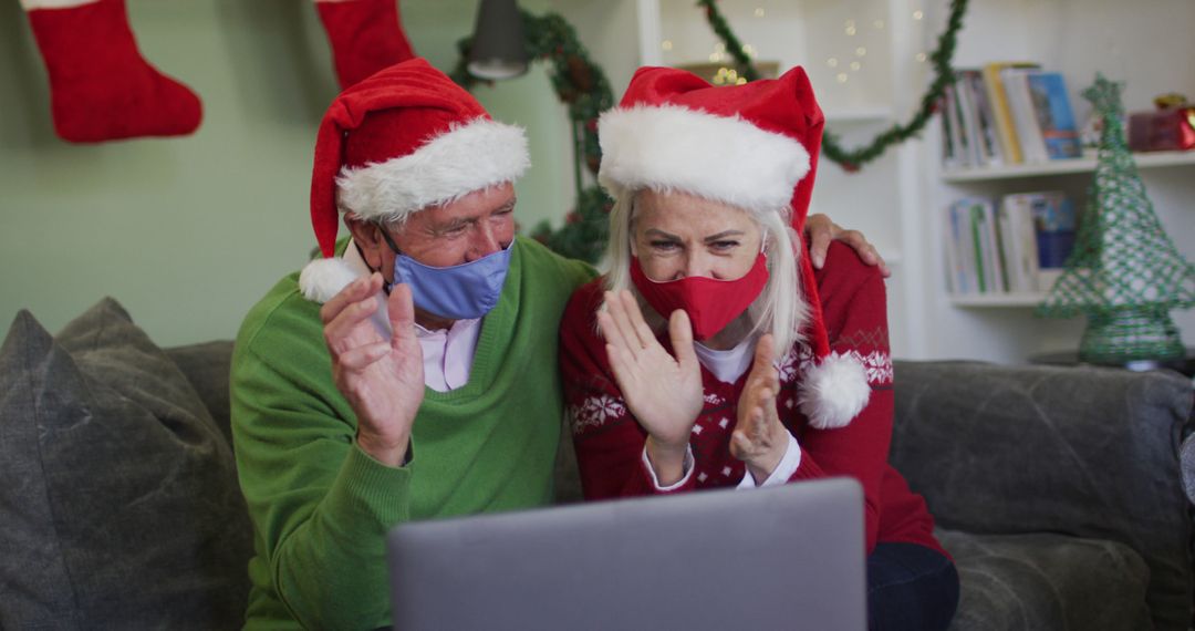 Elderly Couple in Santa Hats Video Calling Family During Christmas - Free Images, Stock Photos and Pictures on Pikwizard.com