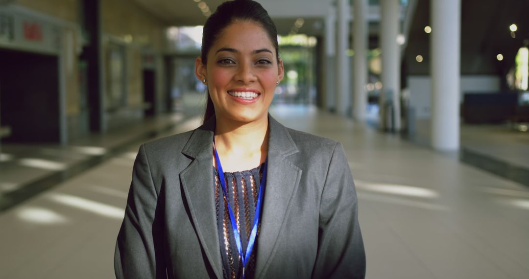 Confident Businesswoman Smiling in Modern Office Building - Free Images, Stock Photos and Pictures on Pikwizard.com