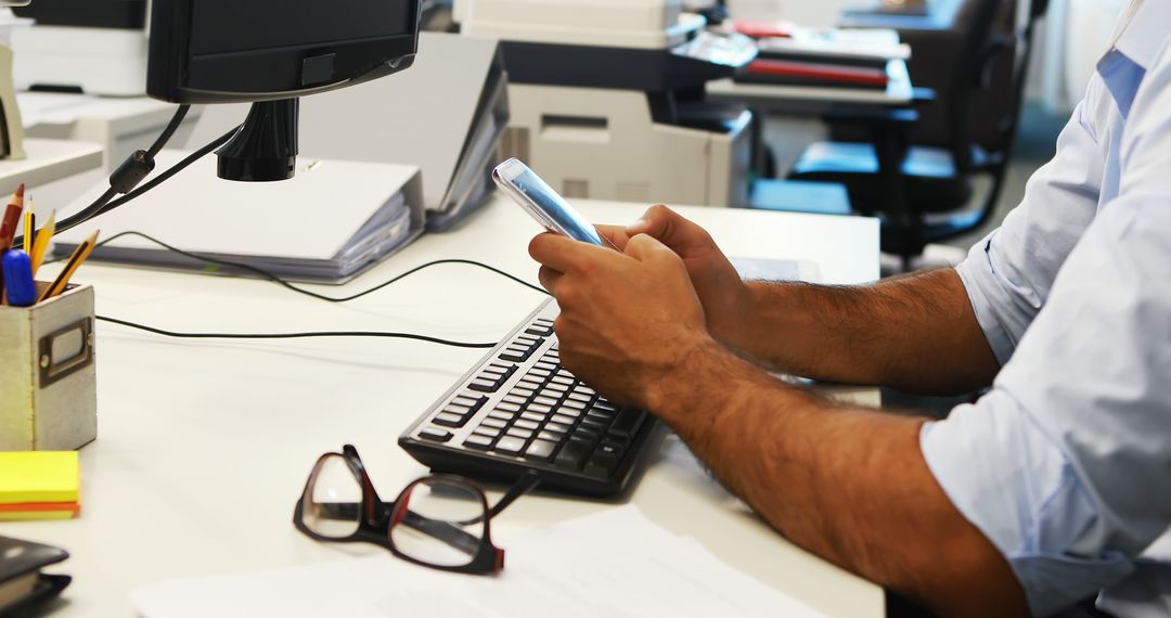 Office Worker Using Smartphone at Desk - Free Images, Stock Photos and Pictures on Pikwizard.com