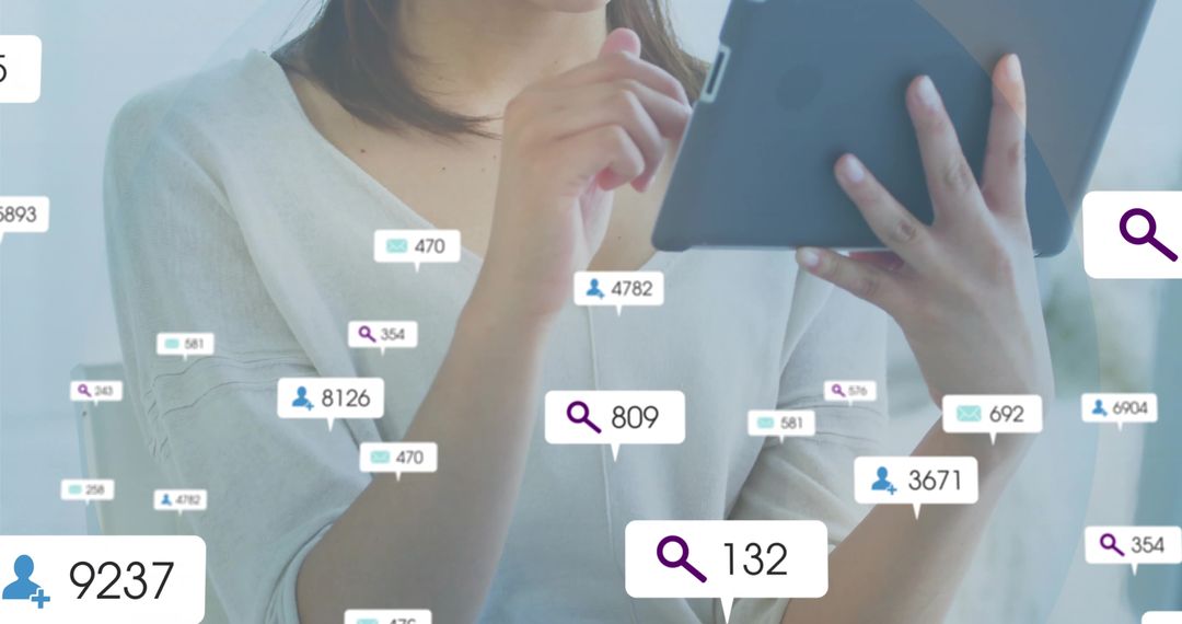 Woman Using Tablet Displaying Notifications in Modern Office Environment