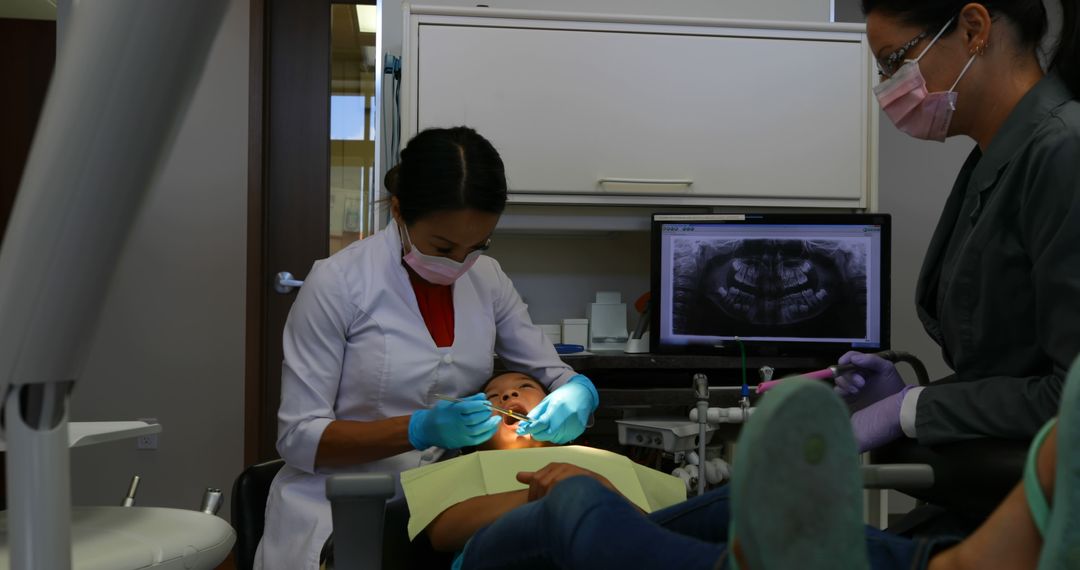 Pediatric Dentist Examining Child's Teeth in Modern Dental Office - Free Images, Stock Photos and Pictures on Pikwizard.com