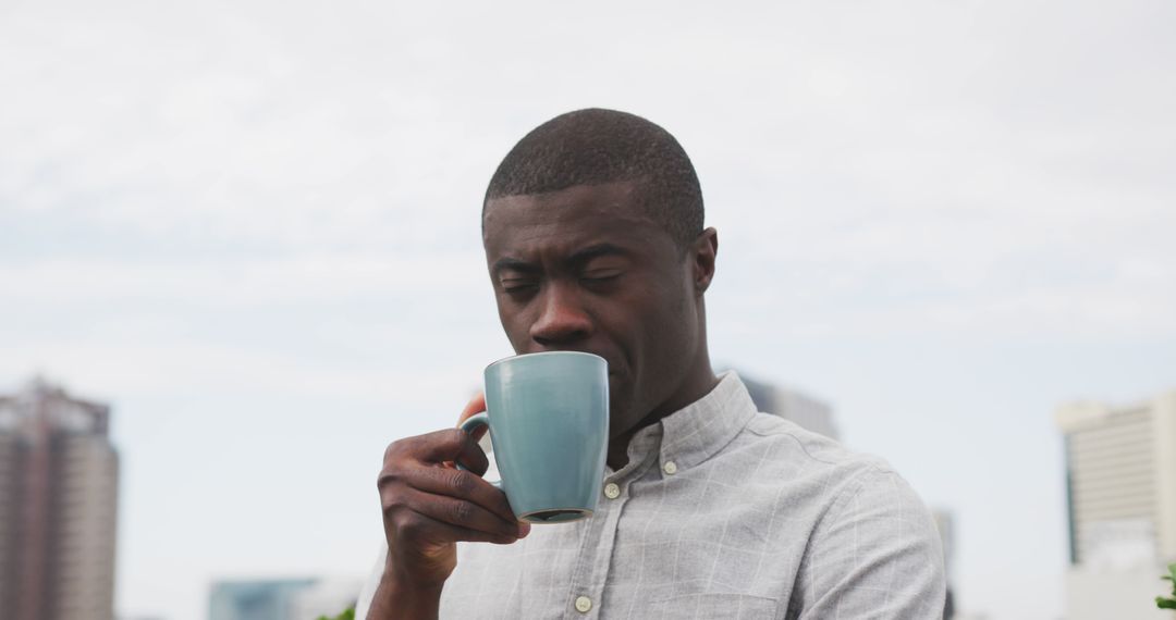 Man Enjoying Coffee Outside on Bright Day - Free Images, Stock Photos and Pictures on Pikwizard.com