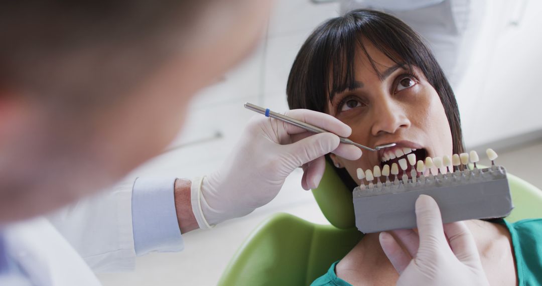 Woman Receiving Dental Treatment with Shade Guide - Free Images, Stock Photos and Pictures on Pikwizard.com