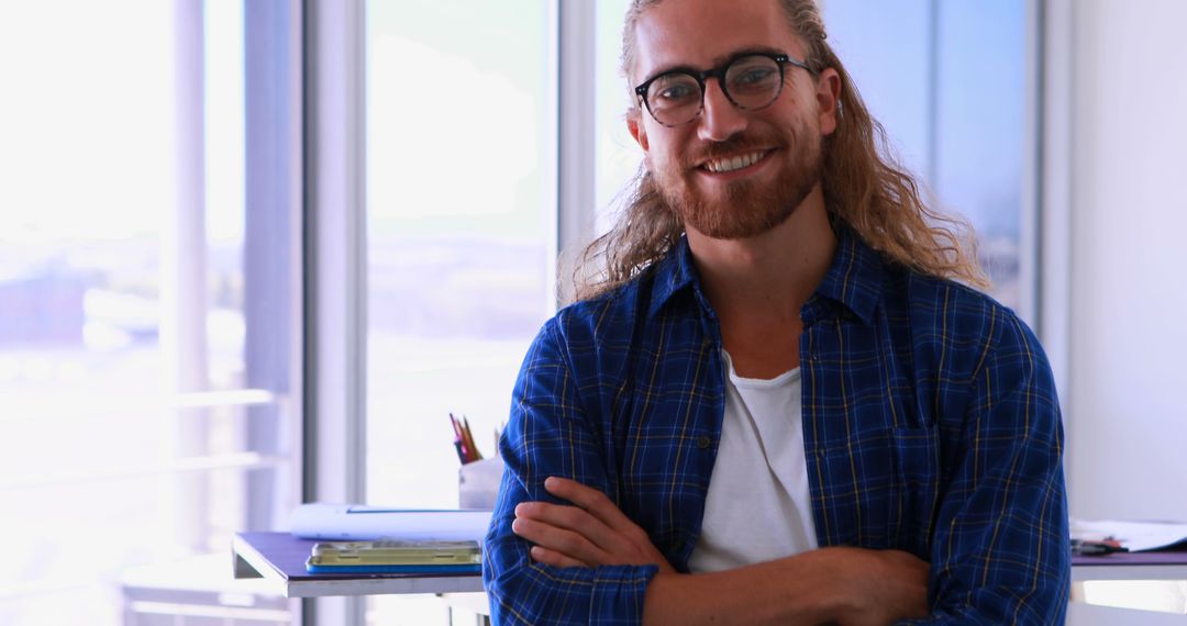Confident Young Man Smiling in Casual Office Environment