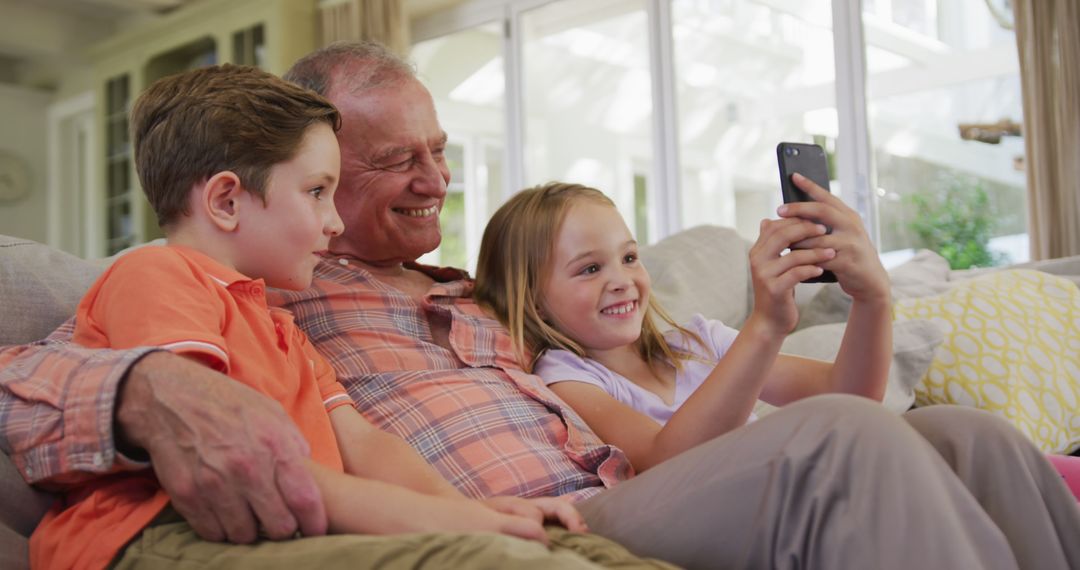 Grandfather with Grandchildren Watching Video on Smartphone - Free Images, Stock Photos and Pictures on Pikwizard.com