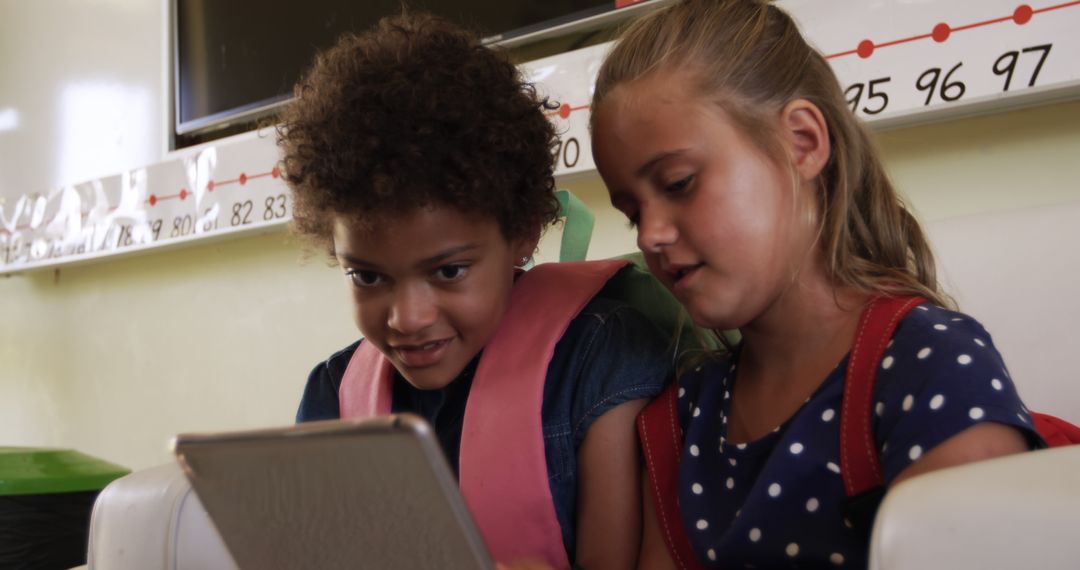 Diverse Students Sharing Tablet in Classroom