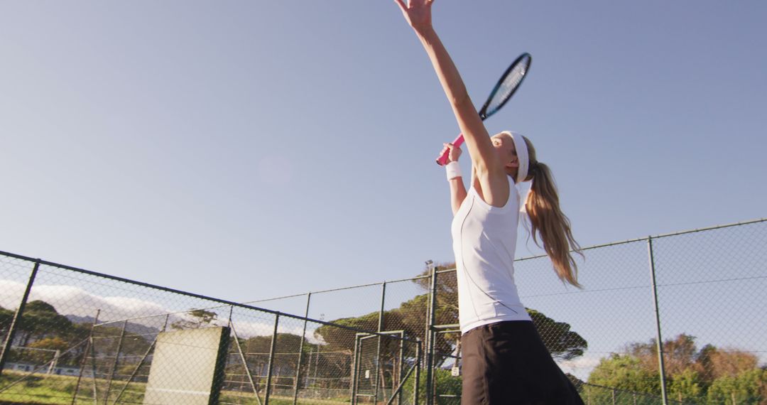 Image of happy caucasian female tennis player holding racket and hitting ball - Free Images, Stock Photos and Pictures on Pikwizard.com