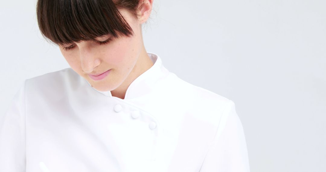 Female Chef in White Uniform Focusing While Cooking - Free Images, Stock Photos and Pictures on Pikwizard.com