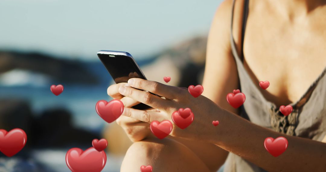 Woman Texting on Beach with Digital Hearts Overlay