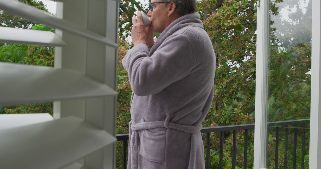 Senior Man Reflecting on Balcony with Morning Coffee - Free Images, Stock Photos and Pictures on Pikwizard.com