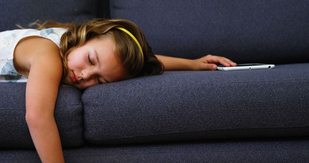 Young Girl Sleeping on Couch with Hand on Tablet - Free Images, Stock Photos and Pictures on Pikwizard.com