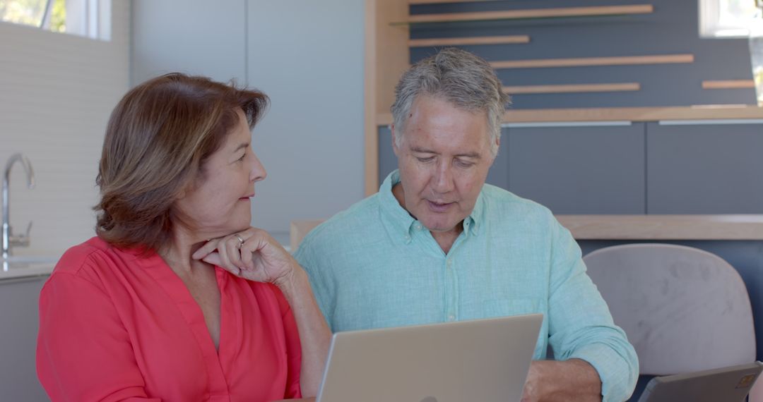 Senior Couple Using Laptop for Online Management at Home