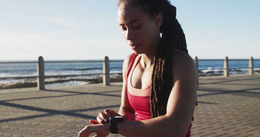 Fit Woman Checking Smartwatch During Outdoor Workout - Free Images, Stock Photos and Pictures on Pikwizard.com