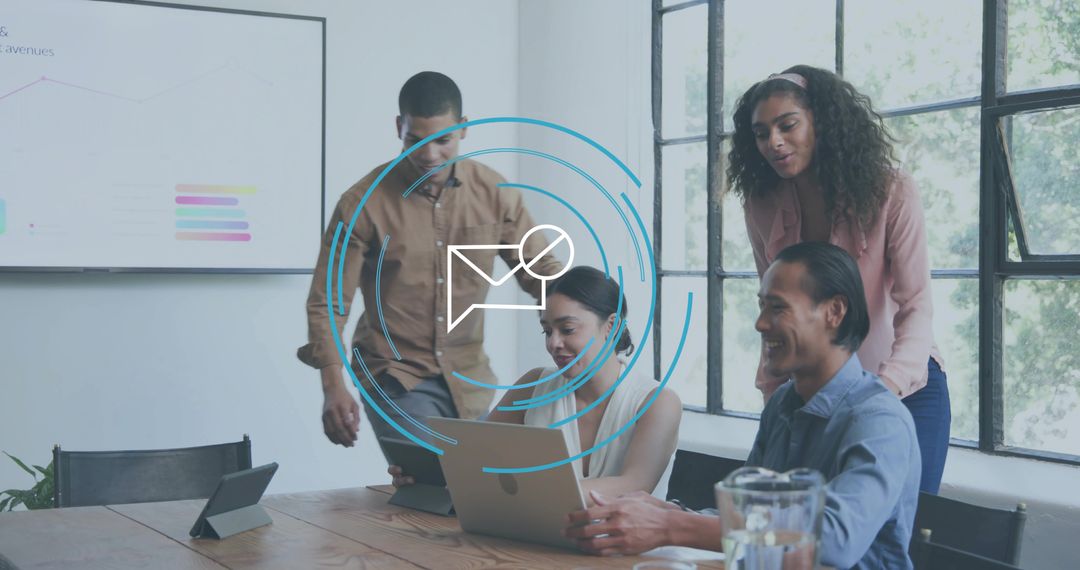 Business team collaborating around laptop and tablet while reviewing charts in modern boardroom