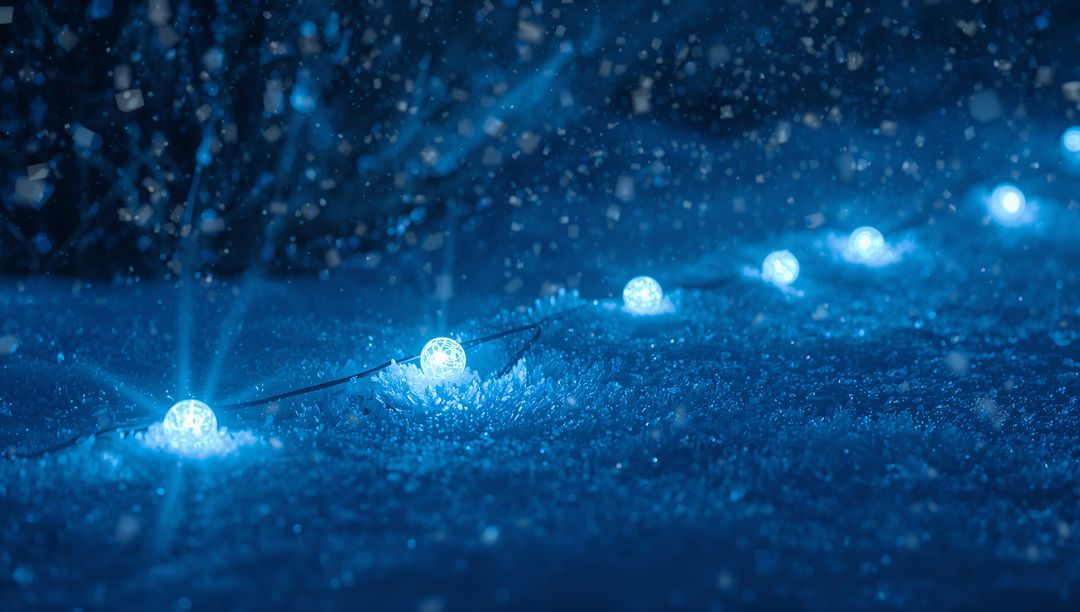 Glowing Blue Spherical LED String Lights Casting Soft Halos on Snow at Night Frosty Bokeh