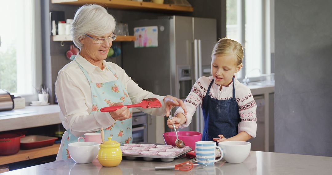 Grandmother and Granddaughter Baking Cupcakes Together in Kitchen - Free Images, Stock Photos and Pictures on Pikwizard.com