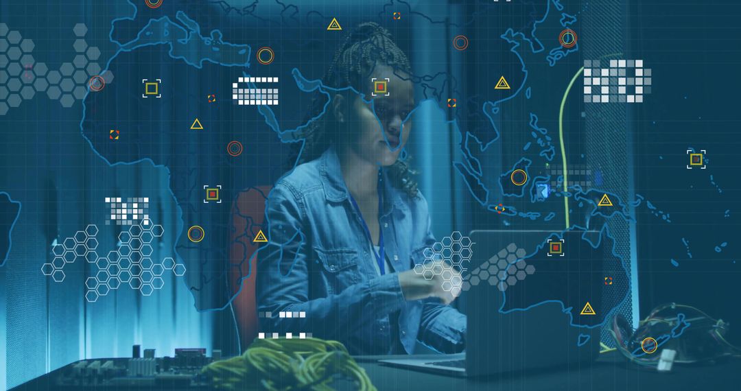 Engineer Operating Computer in Cybersecurity Lab with Digital Map Overlay
