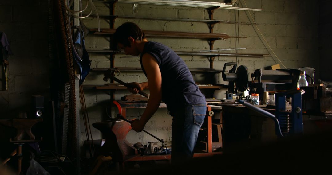 Female Metalsmith Crafting Horseshoe in Dim Workshop