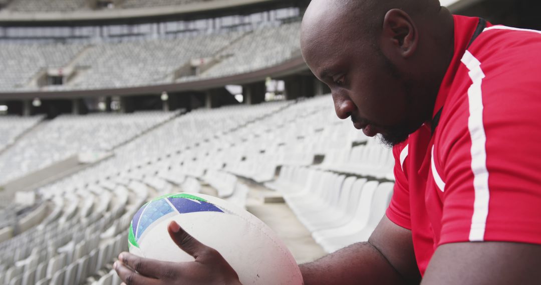 Thoughtful Rugby Player Holding Ball in Stadium - Free Images, Stock Photos and Pictures on Pikwizard.com