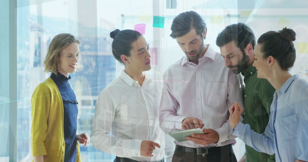 Diverse Colleagues Discussing Data on Digital Tablet in Modern Office