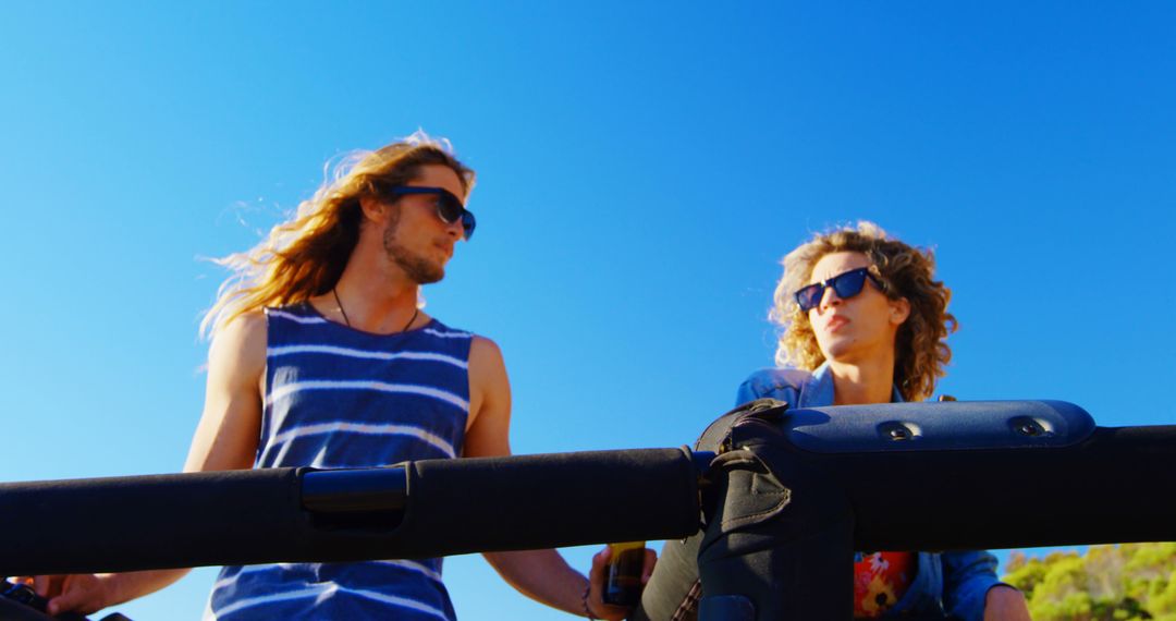 Young Couple Enjoying a Road Trip Under Clear Blue Sky - Free Images, Stock Photos and Pictures on Pikwizard.com