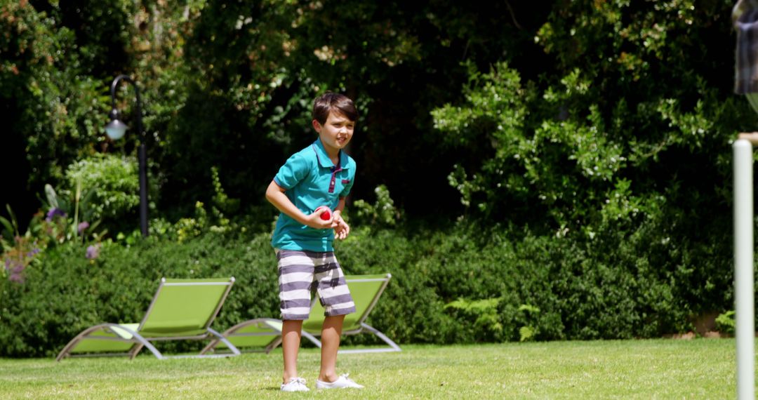 Boy Playing Lawn Game in Sunny Garden - Free Images, Stock Photos and Pictures on Pikwizard.com