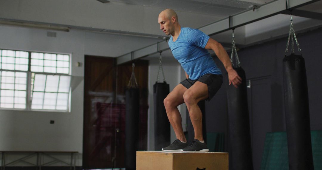 Man Exercising with Box Jumps in Gym - Free Images, Stock Photos and Pictures on Pikwizard.com