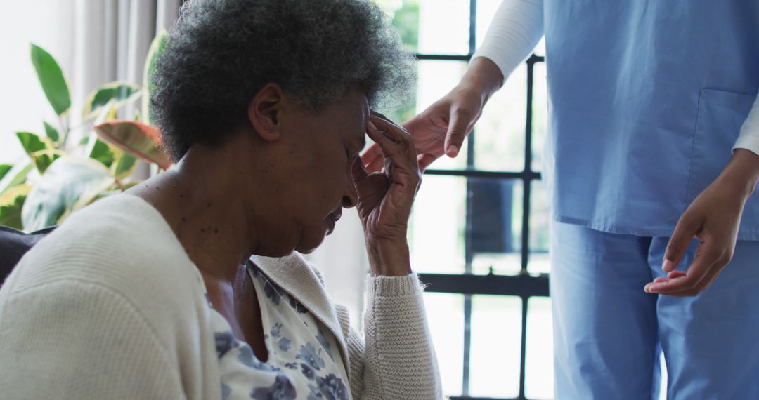 Elderly Woman Feeling Distressed with Nurse Offering Support - Free Images, Stock Photos and Pictures on Pikwizard.com