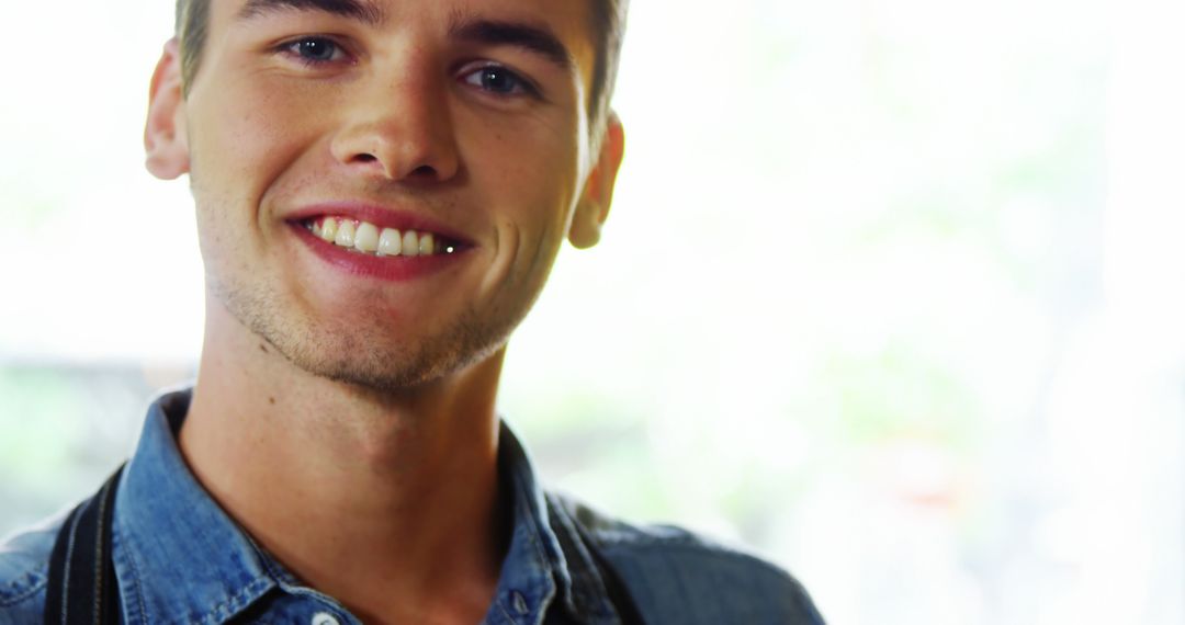 Young Man Smiling in Casual Denim Shirt - Free Images, Stock Photos and Pictures on Pikwizard.com