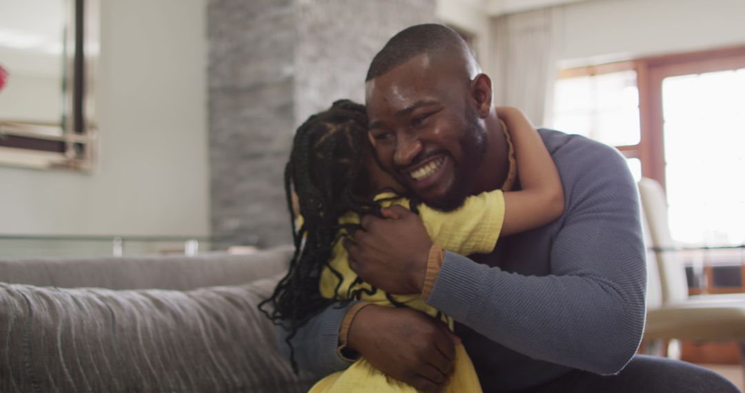 Loving Father and Daughter Embracing on Comfortable Sofa