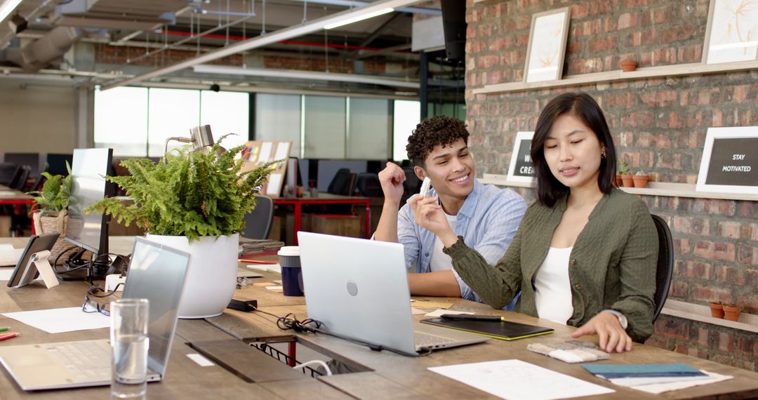 Diverse Coworkers Collaborating in Modern Work Space